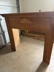 Wood Fireplace Mantel Surround With Decorative Carving, Medium Tone. Fixed Price $150.00.